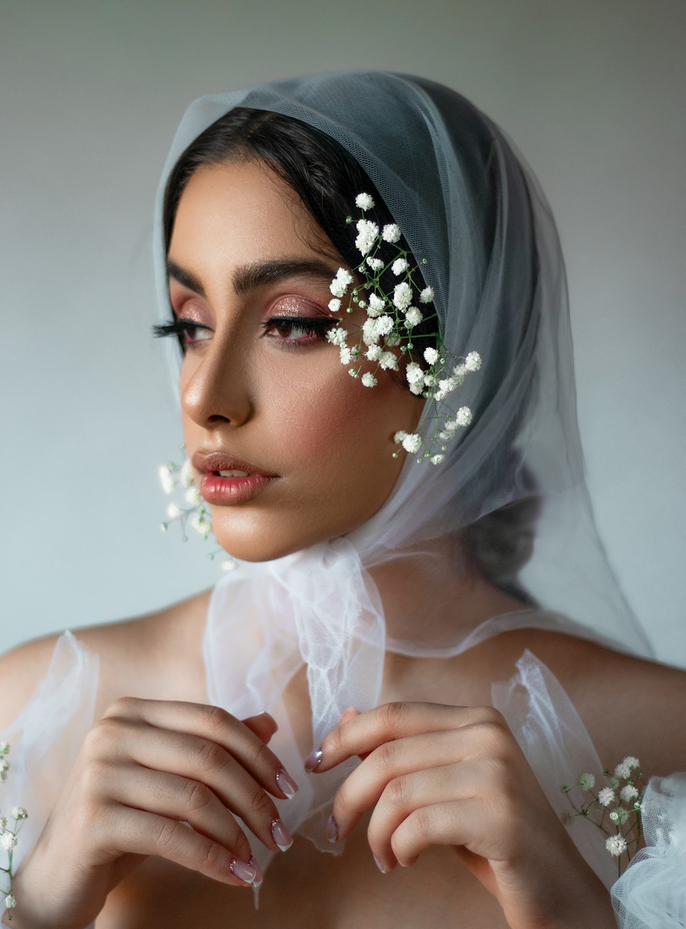 a woman with a veil and flowers in her hair