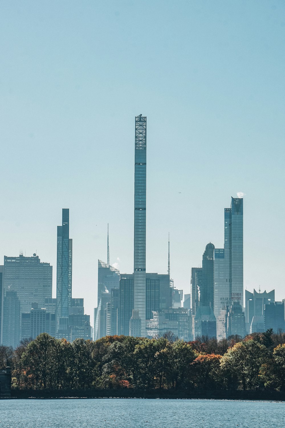 a view of a city skyline with a lake in the foreground