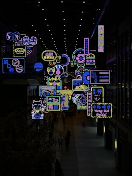 a large display of neon signs in a building
