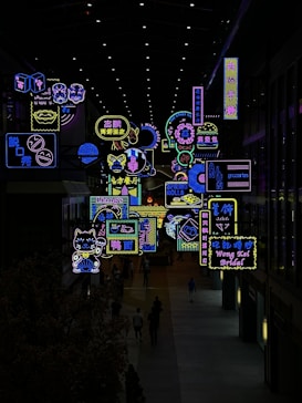 a large display of neon signs in a building