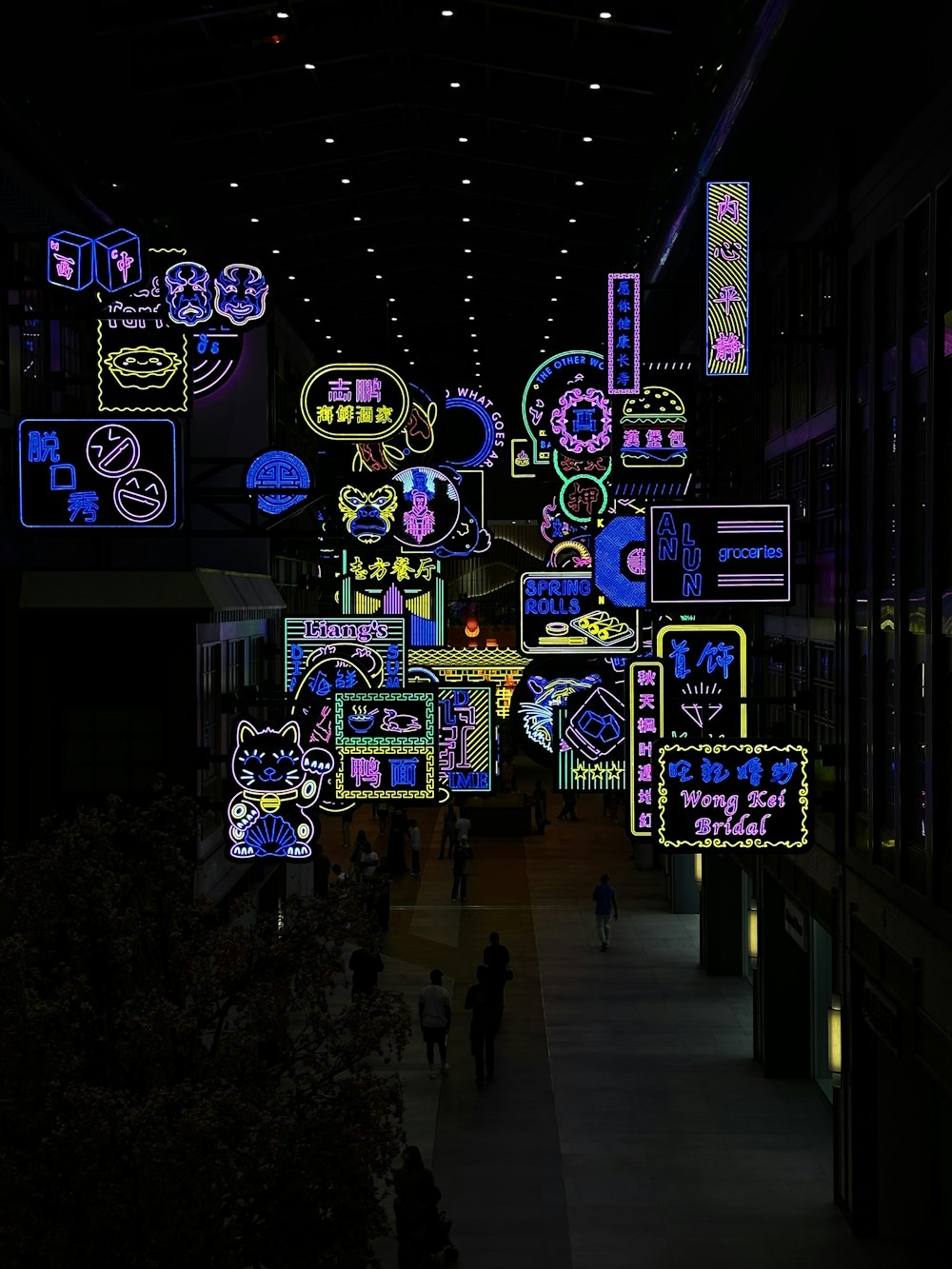 a large display of neon signs in a building