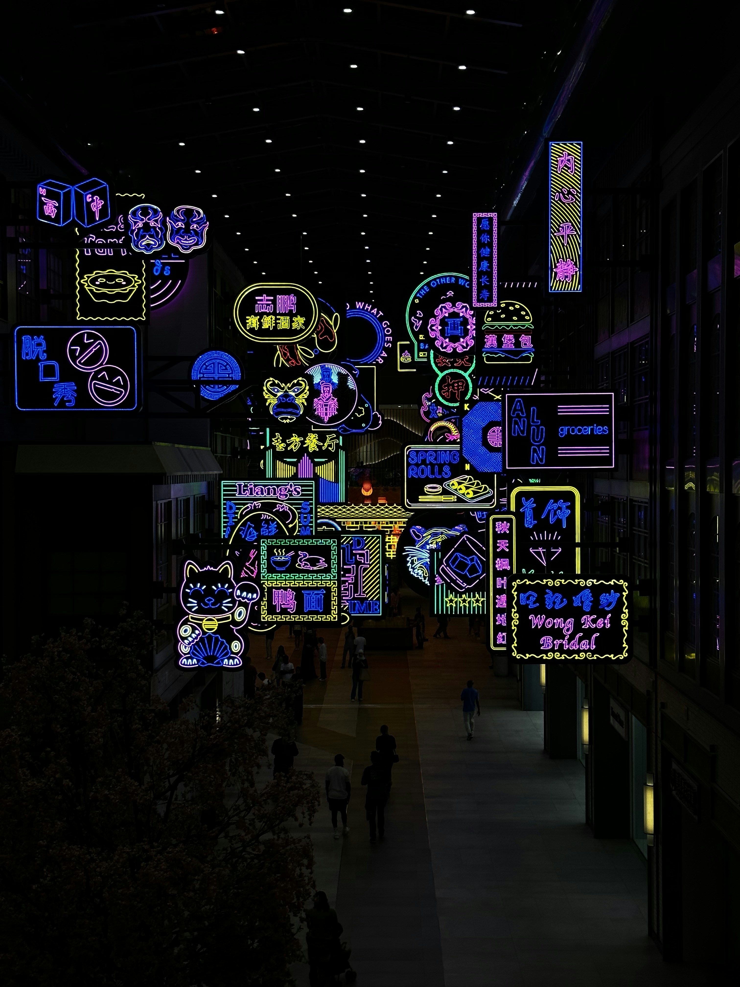 Branimo neon signs display in building, showcasing vibrant lighting and modern branding.