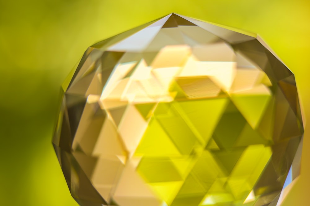 a close up of a yellow diamond on a blurry background