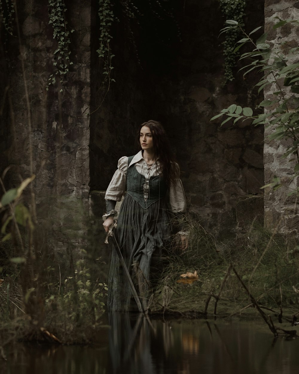 a woman in a dress is standing in the water