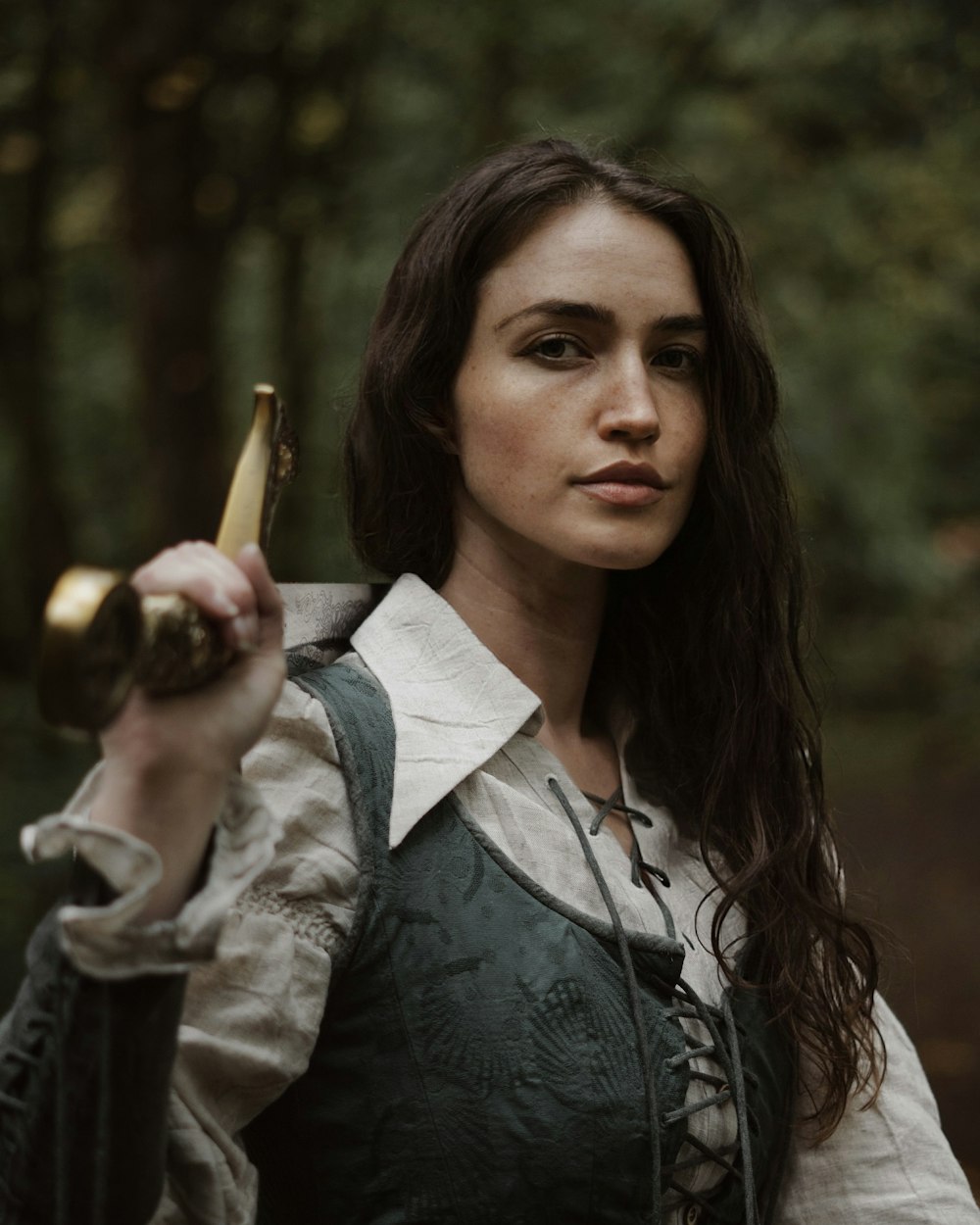 a woman holding a banana in a forest