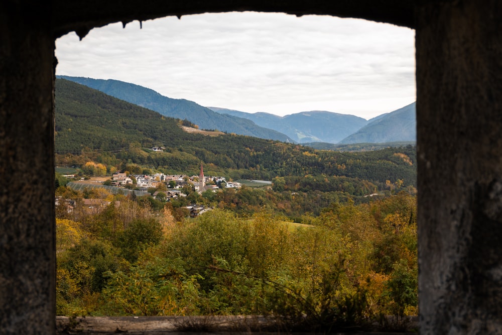 a view of a valley through a hole in a wall