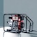 A portable diesel engine generator encased within a black metal frame, featuring a combination of silver, red, and black components. The engine housing displays branding and instructional graphics. The backdrop is a plain, muted gray-blue surface.