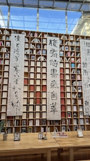 Bookshelf featuring Gerald Sunagel's works alongside zen and taoist philosophy texts
