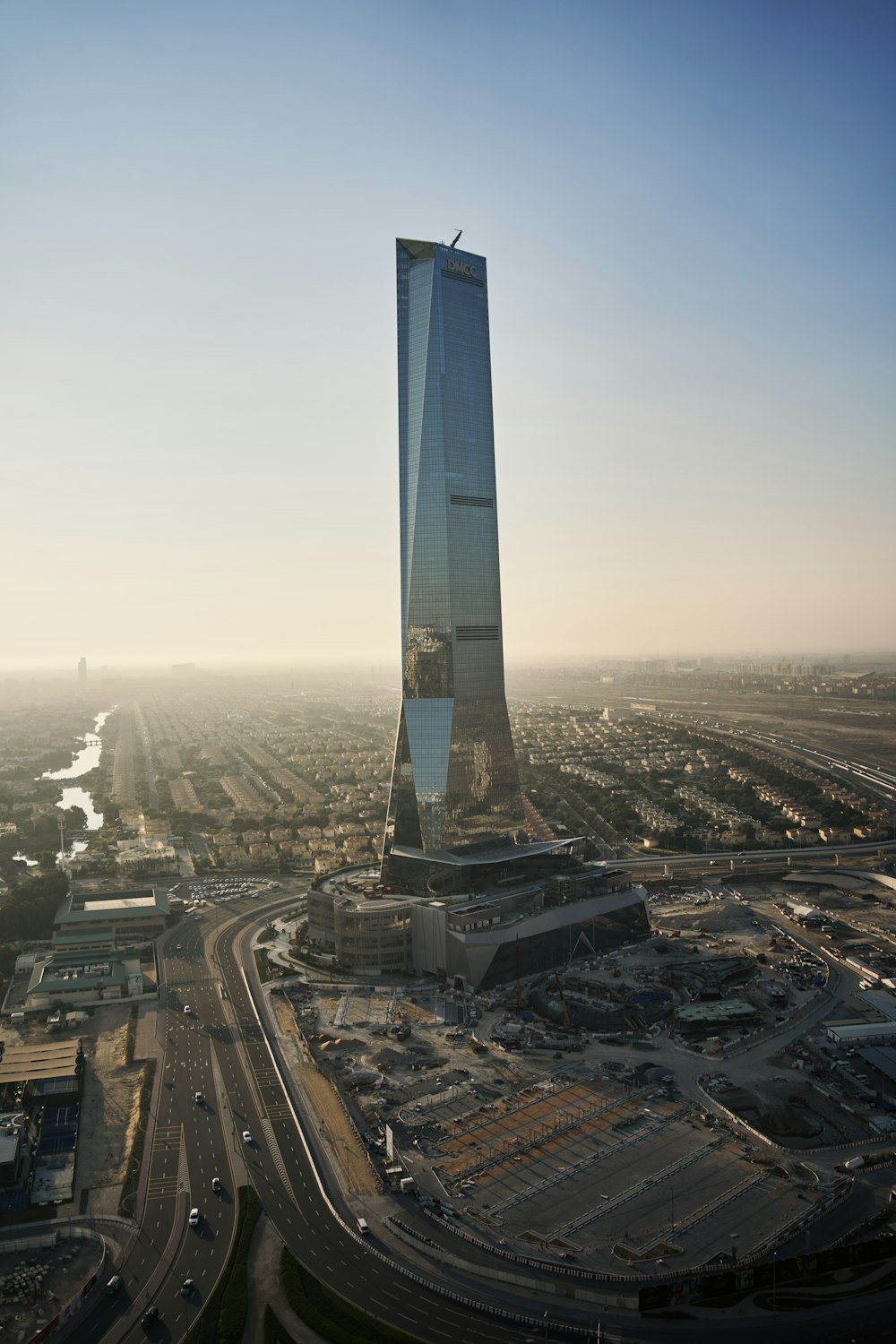 an aerial view of a tall building in a city