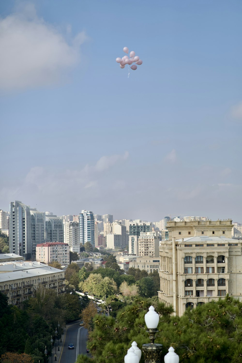 a couple of kites flying over a city