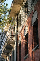 A close-up of intricate woodwork on a restored historic South Flower Street home bathed in golden afternoon light.