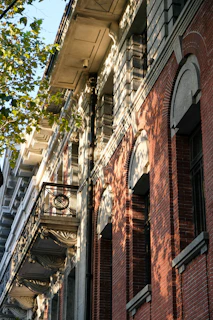 Close-up of intricate architectural details on an old city building, bathed in warm afternoon light.