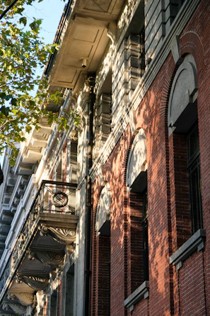 A close-up of intricate woodwork on a restored historic South Flower Street home bathed in golden afternoon light.