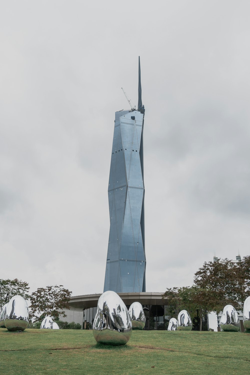 a tall building with a very tall spire in the background