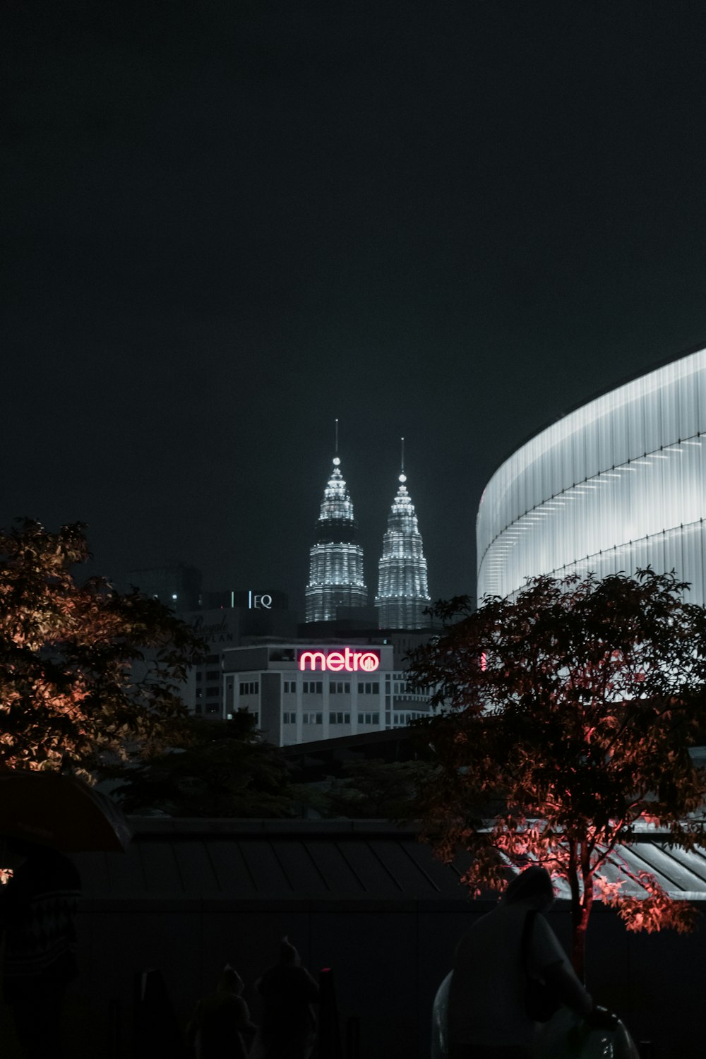 a view of a city at night with a building lit up