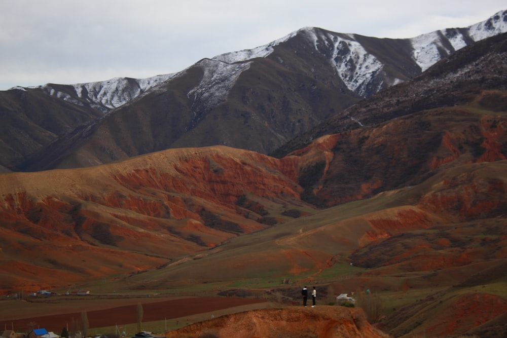 a group of people standing on top of a mountain