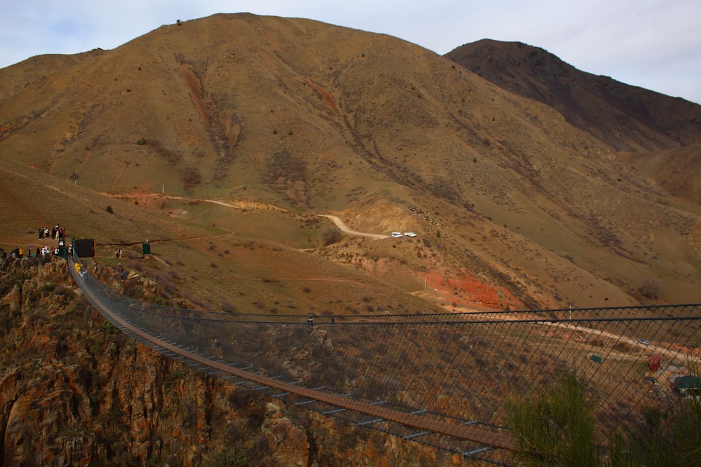 a train on a track near a mountain