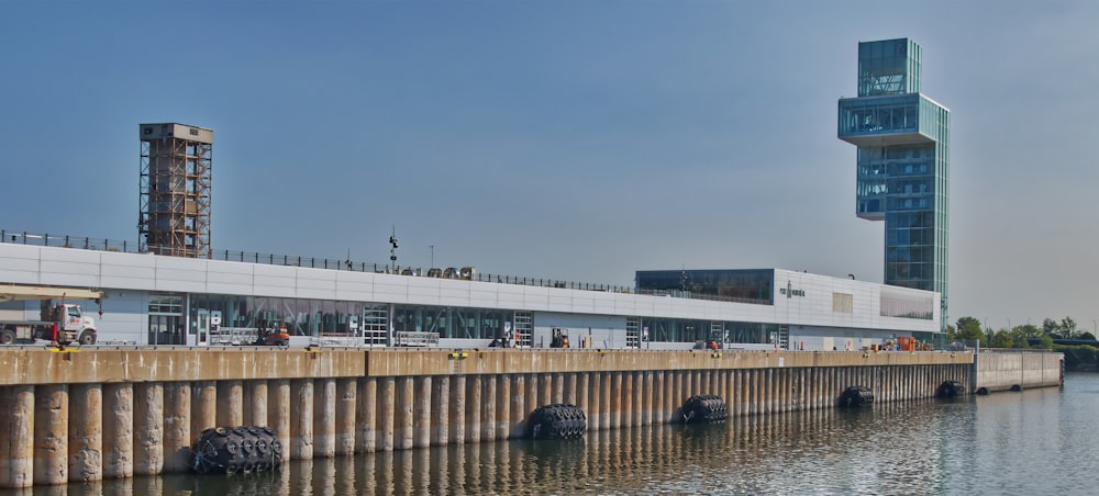 a large body of water next to a tall building