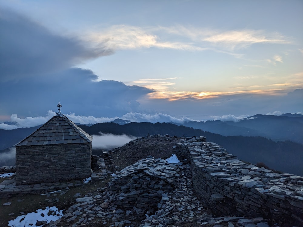 a small building on top of a mountain