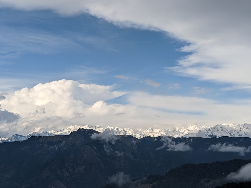 a view of a mountain range with clouds in the sky