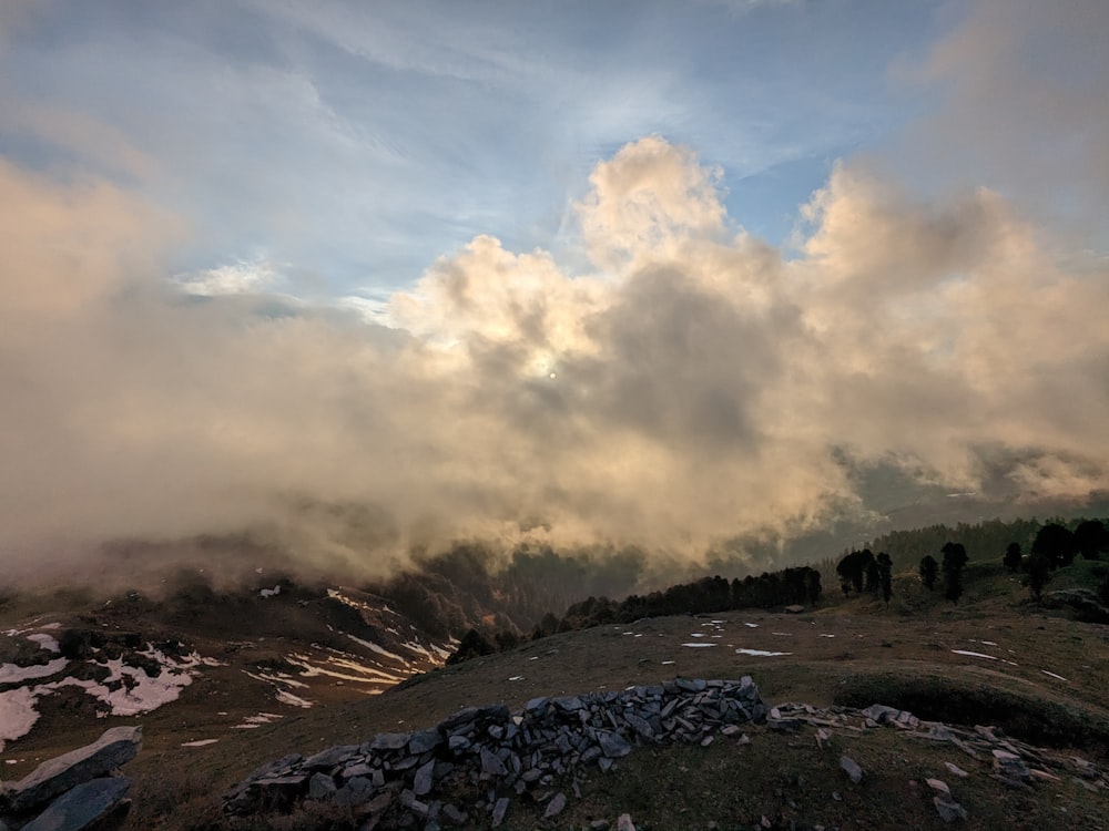 a view of a mountain with clouds in the sky