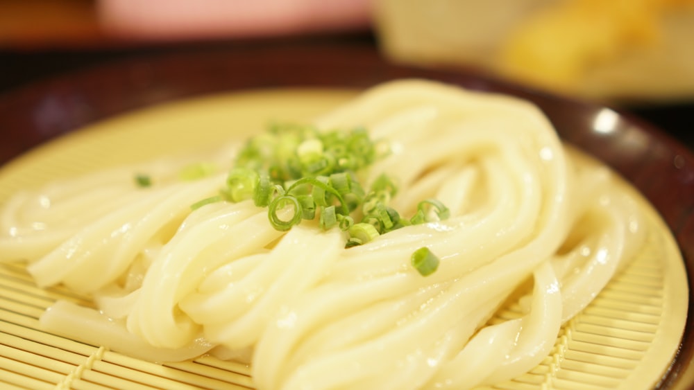 a close up of a plate of food with noodles
