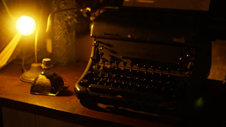 A dimly lit vintage typewriter surrounded by old gothic novels and flickering candlelight.