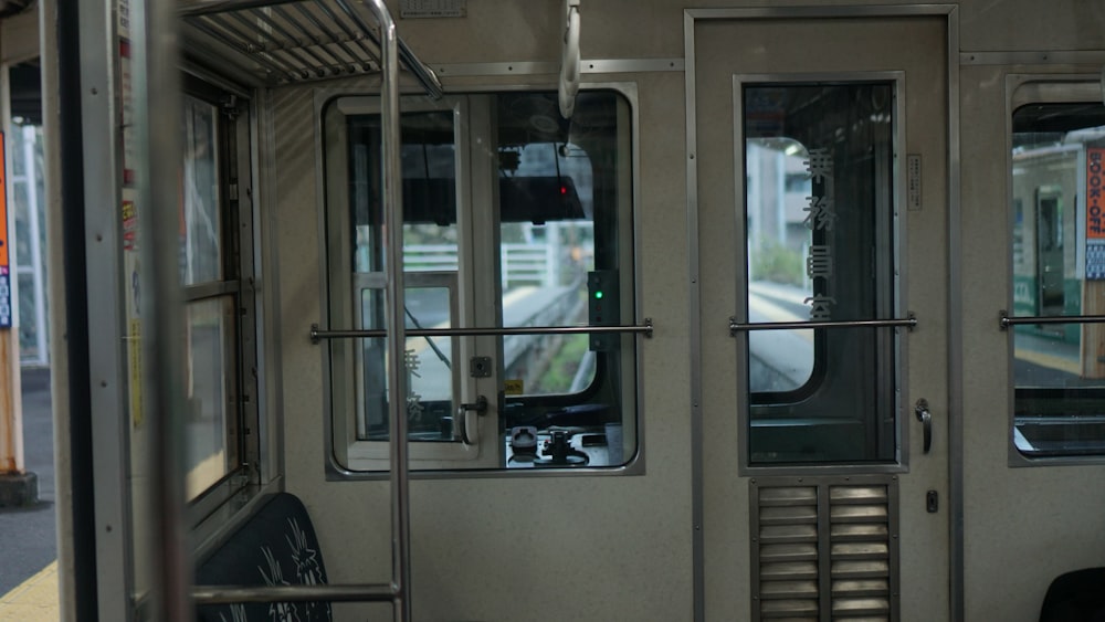 the inside of a subway car with the doors open