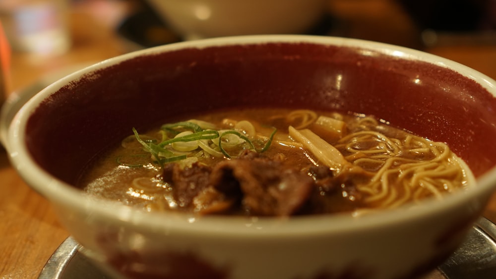 a bowl of soup with noodles and meat