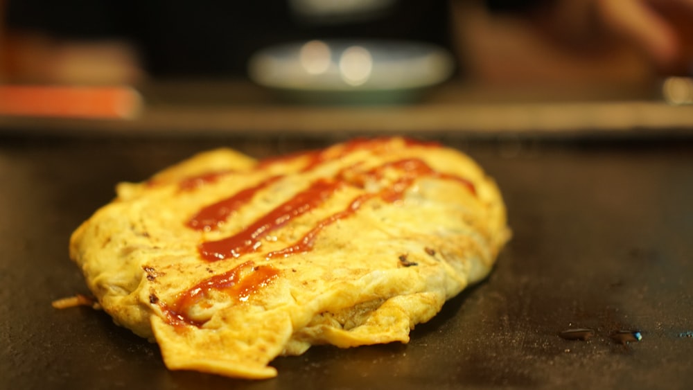 an omelet with ketchup on top of it