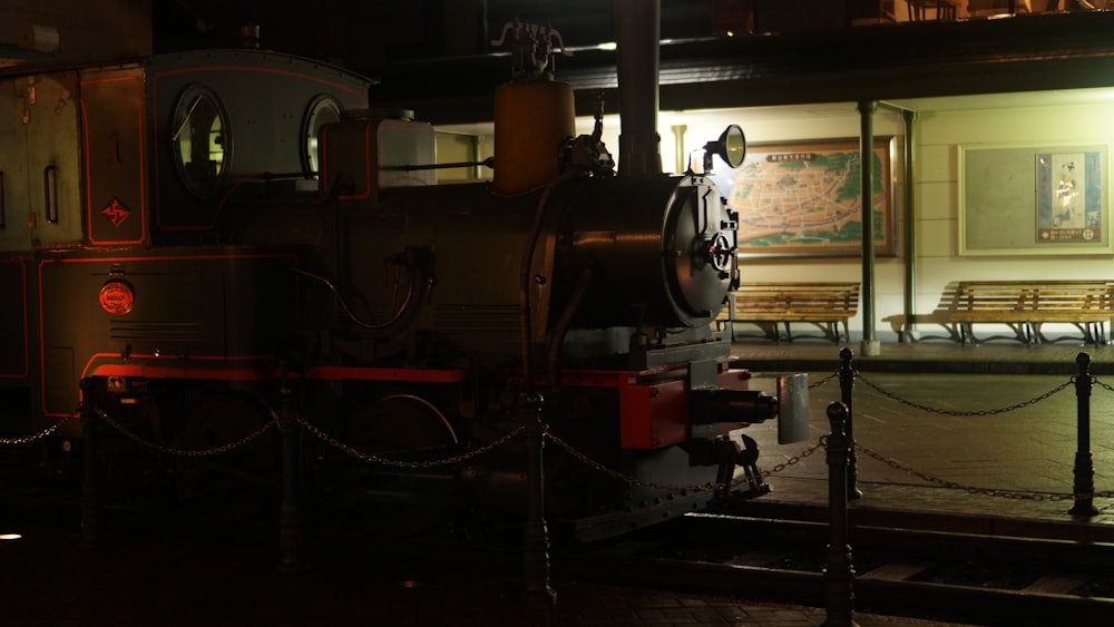 a train parked in front of a building at night