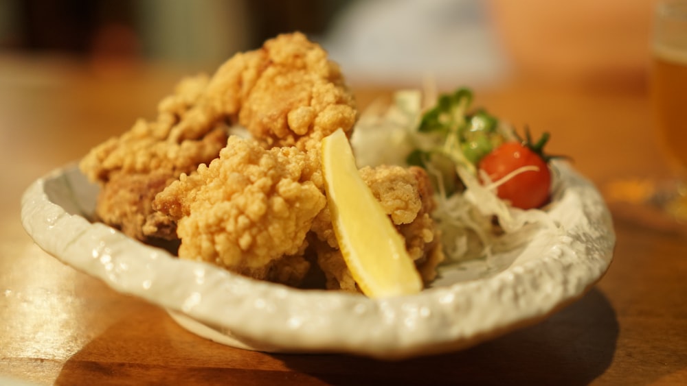 a plate of food on a table with a glass of beer