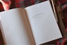 an open book with a pen on top of it