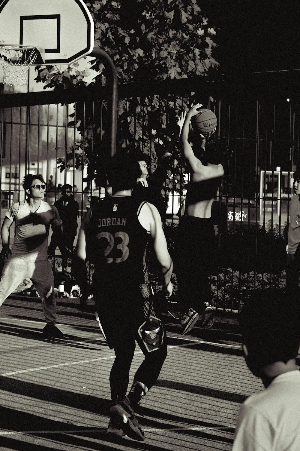 a group of young men playing a game of basketball