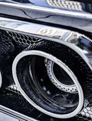 Detailed view of a shiny, newly installed exhaust on a sports car.