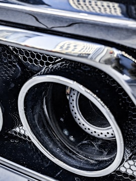 Detailed view of a shiny, newly installed exhaust on a sports car.