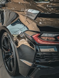 A sleek personal car with a deep, reflective ceramic coating finish.