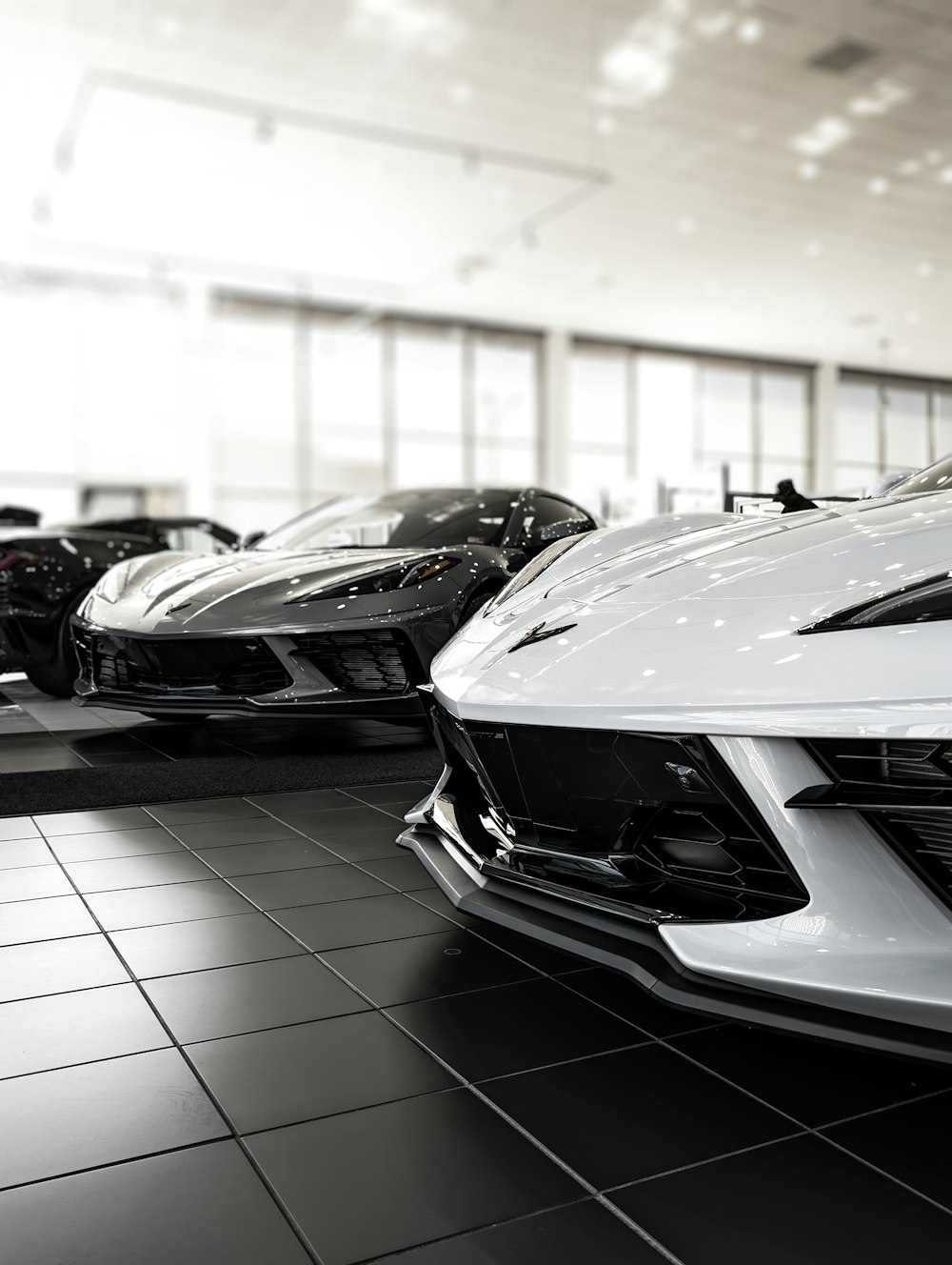 a row of sports cars in a showroom