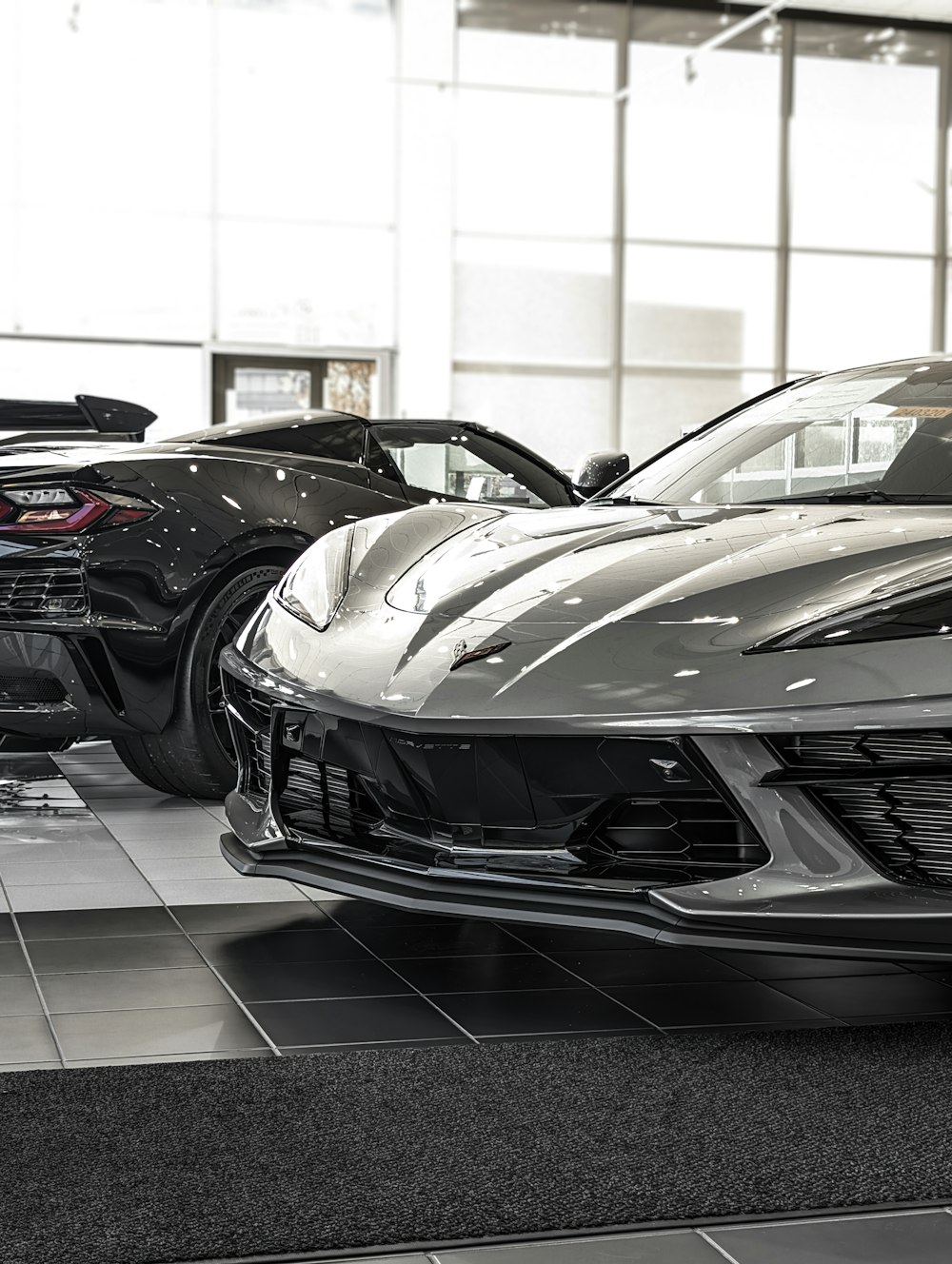 a couple of cars are parked in a showroom