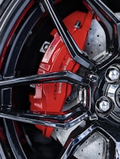 Close-up of a high-performance brake disc and caliper with a dark blue finish.