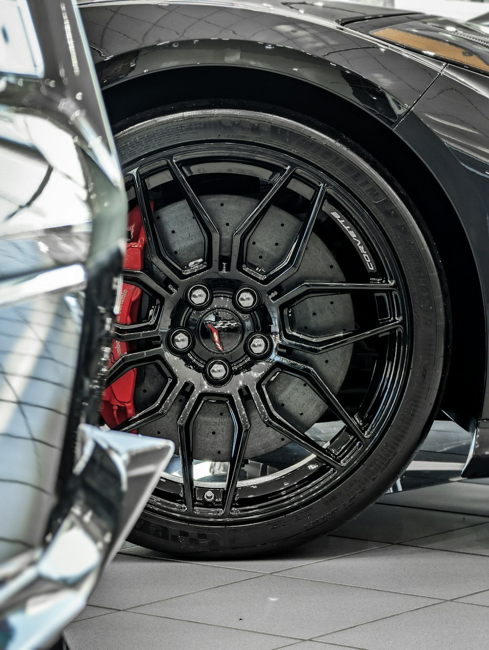 a close up of a black sports car tire
