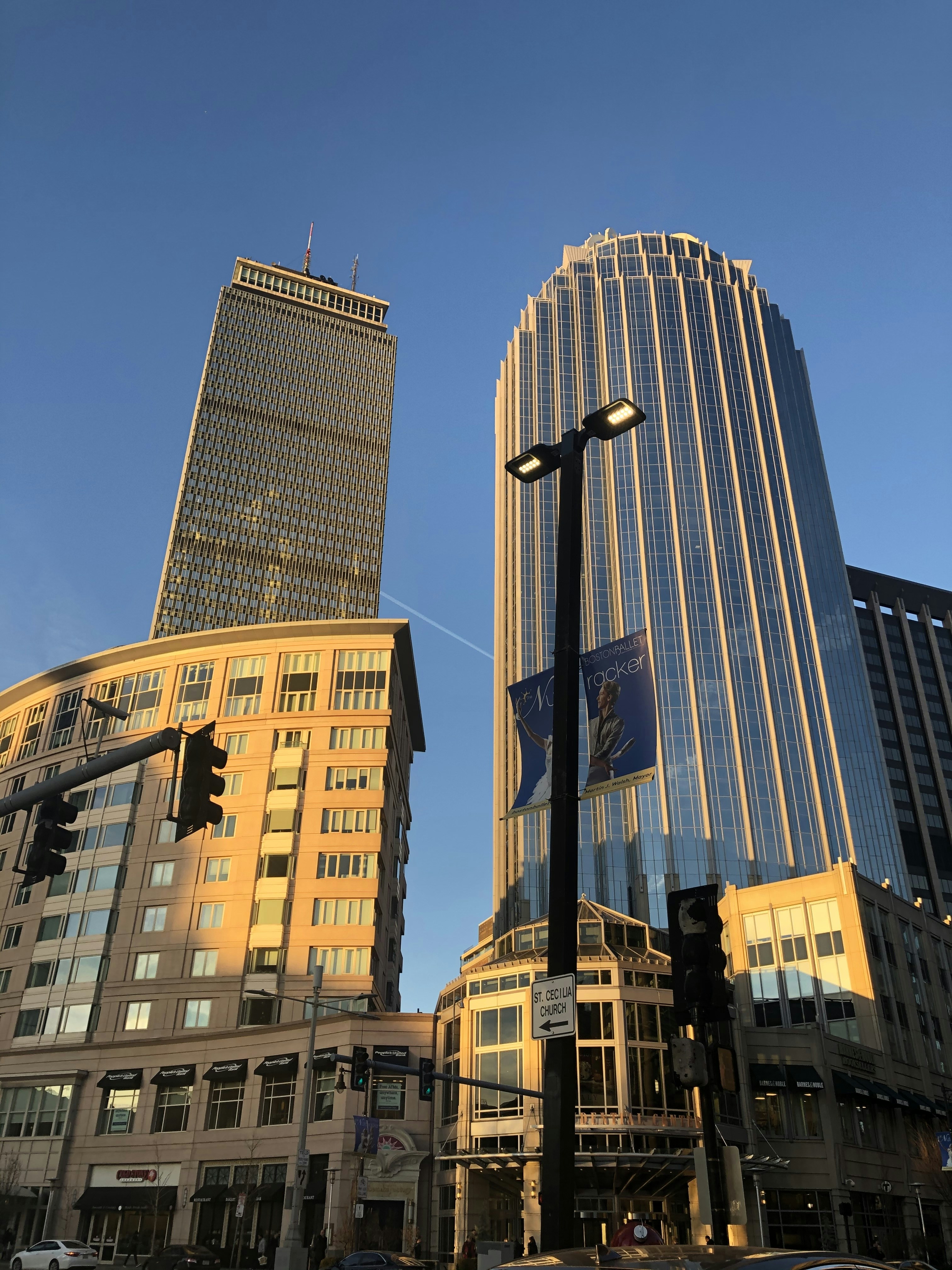a city street with tall buildings in the background