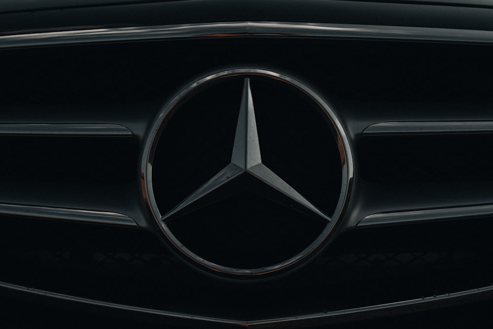 a close up of a mercedes logo on a car