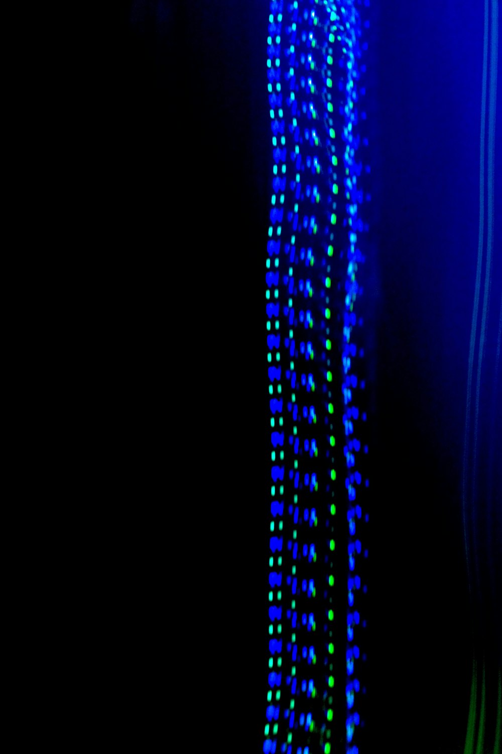 a black background with blue and green lights
