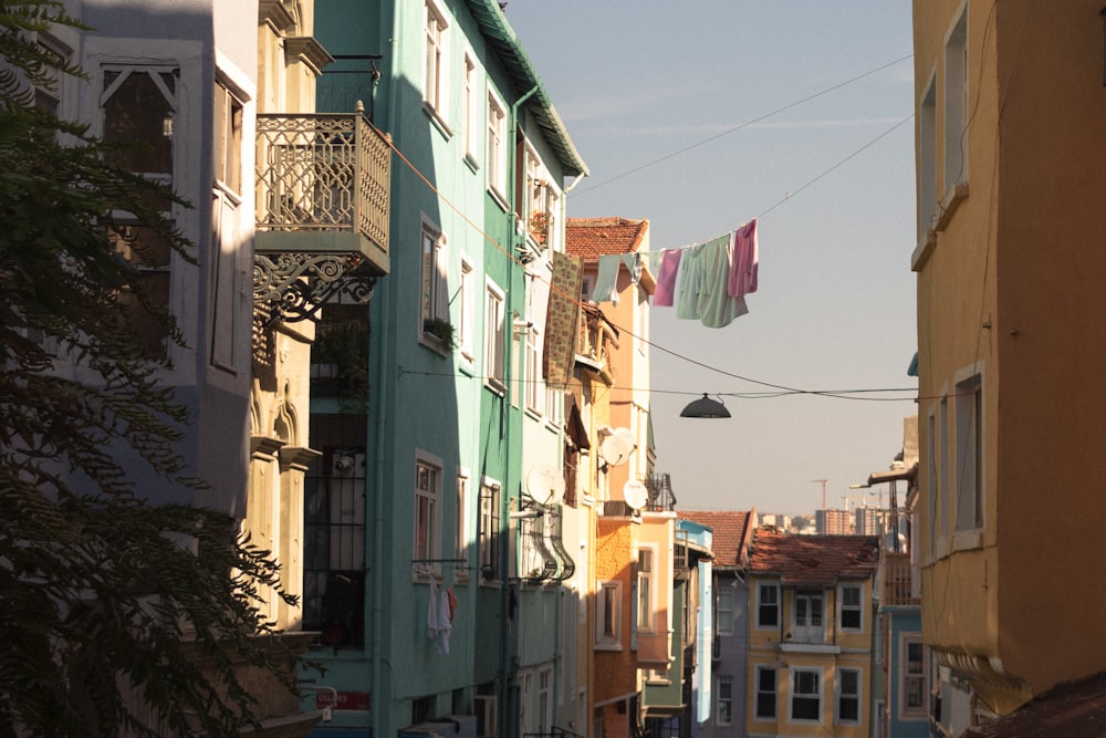a city street with buildings and clothes hanging from a line