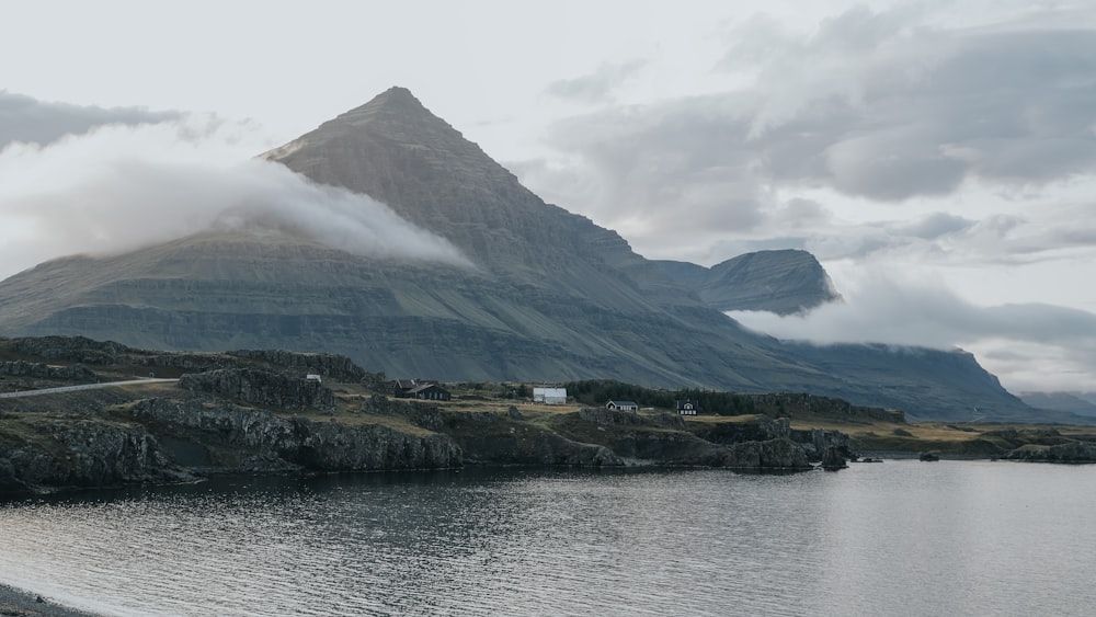 a large mountain with a lake in front of it