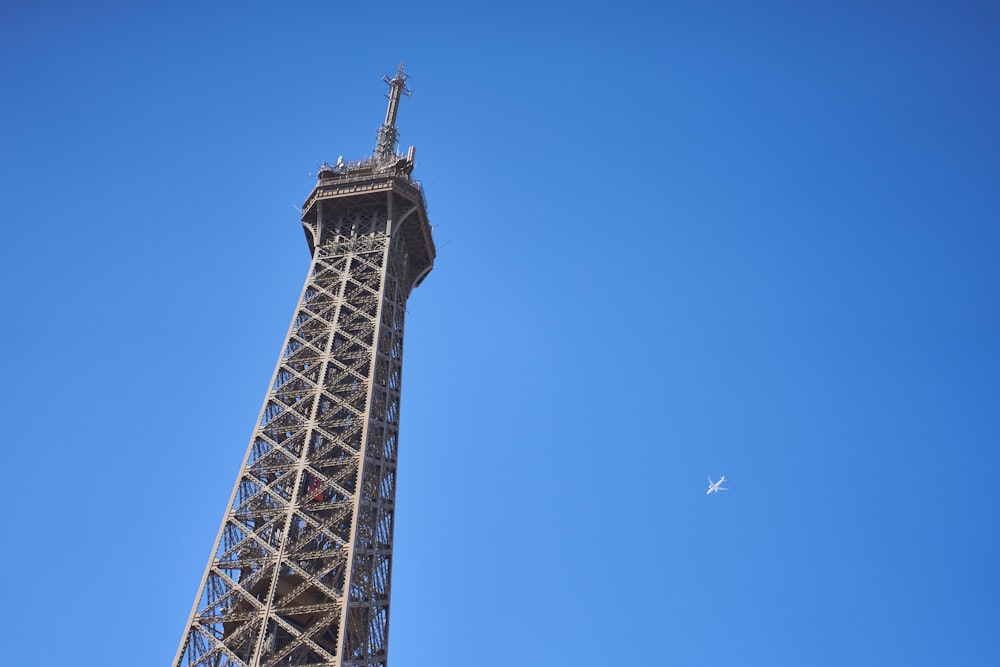a plane flying by the eiffel tower in paris