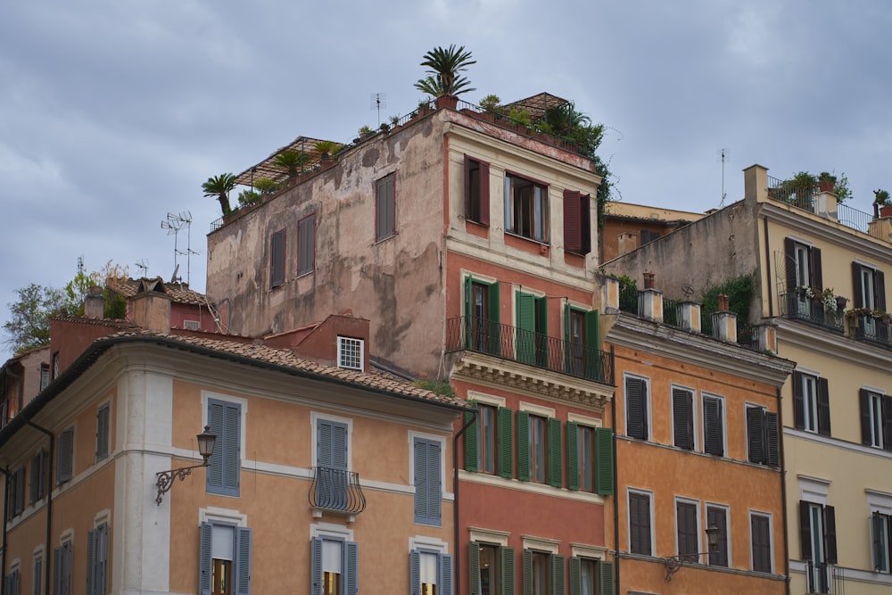 a row of buildings with green shutters and windows