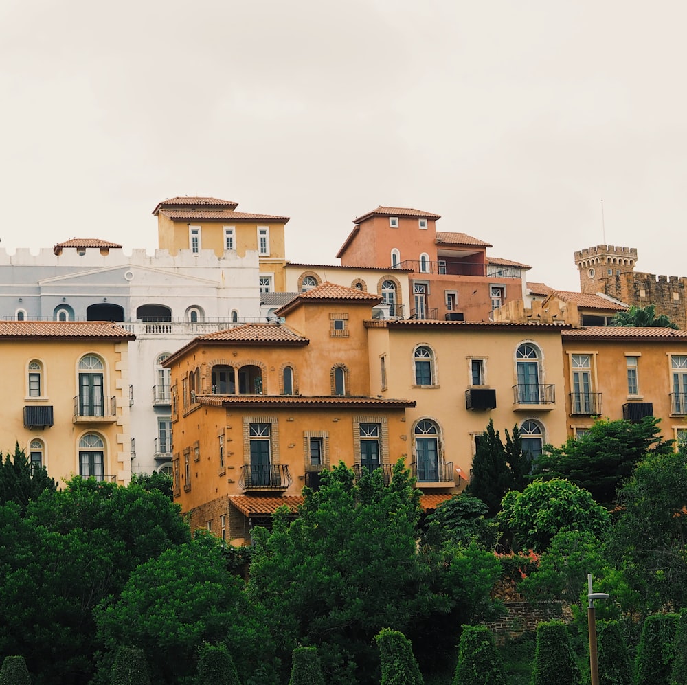 a row of buildings with trees in front of them