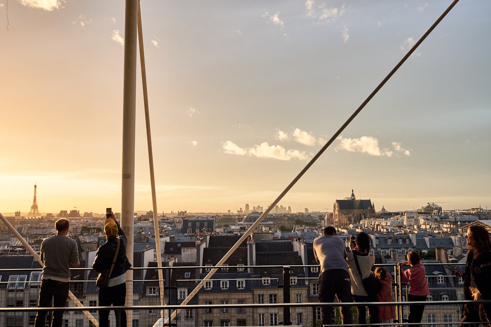 a group of people standing on top of a tall building